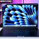 15-inch MacBook Air with a vibrant blue abstract screen pattern on a desk, featuring a Black Friday Sale badge in the corner.