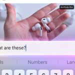 Smartphone screen showing a hand holding white wireless earbuds labeled AirPods Pro, with a glowing text box below containing the question What are these above a virtual keyboard