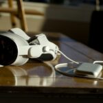 Apple Vision Pro VR headset on a wooden table sitting beside it