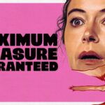 Pink Apple TV promo poster with bold black text reading MAXIMUM PLEASURE GUARANTEED and a close-up of a surprised woman