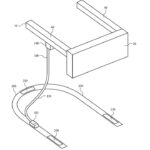 Technical line drawing of a U shaped frame with a rectangular block on top and a curved cable leading to flat rectangular pads along the base, labeled with reference numbers